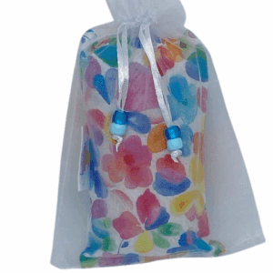 Colorful floral soap bars packaged in white mesh bags.